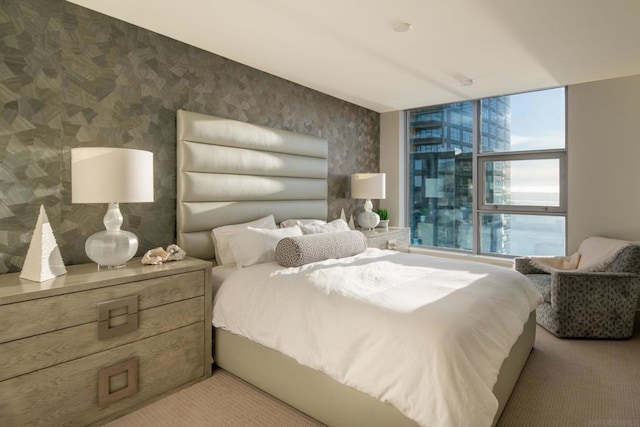 bedroom with expansive windows and carpet