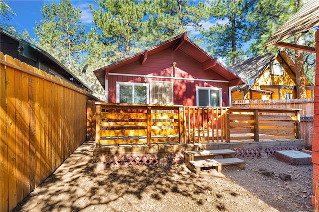 rear view of house featuring a deck