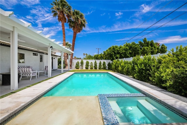 view of swimming pool featuring a patio and an in ground hot tub