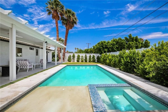 view of pool featuring a patio area, a fenced backyard, and a pool with connected hot tub