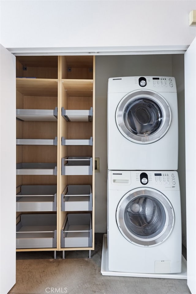 laundry room with stacked washer / dryer