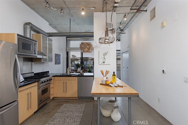 kitchen with sink, light brown cabinetry, a high ceiling, and appliances with stainless steel finishes