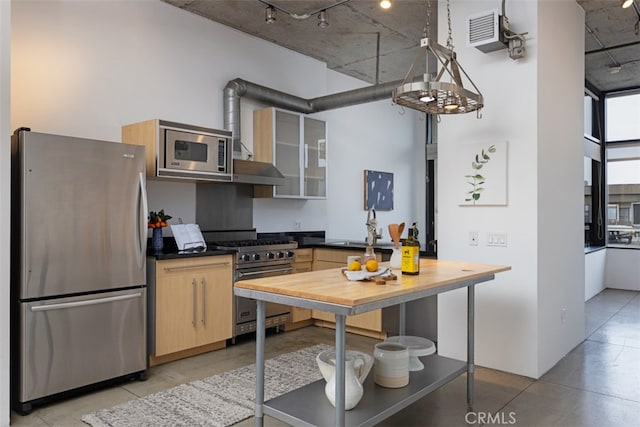 kitchen featuring appliances with stainless steel finishes and light brown cabinets