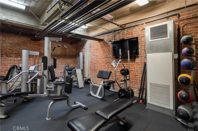 workout area with brick wall