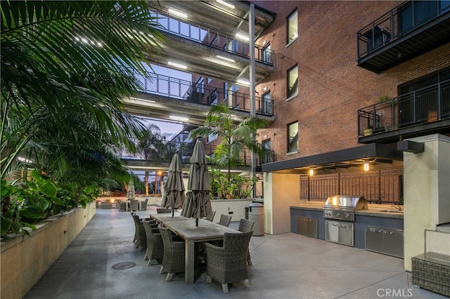 view of patio / terrace with an outdoor kitchen, a grill, and sink