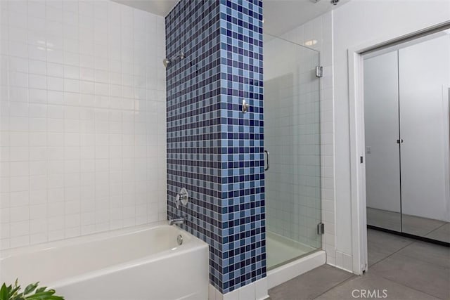 bathroom featuring tile patterned flooring and shower with separate bathtub