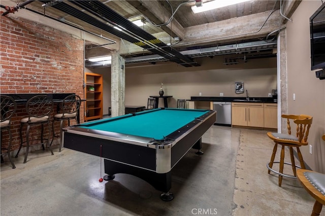 game room with concrete flooring, wet bar, brick wall, and pool table