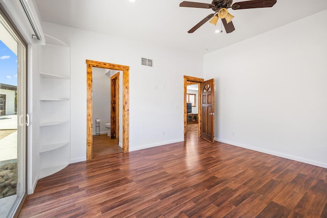 unfurnished room featuring dark hardwood / wood-style floors, ceiling fan, and built in shelves