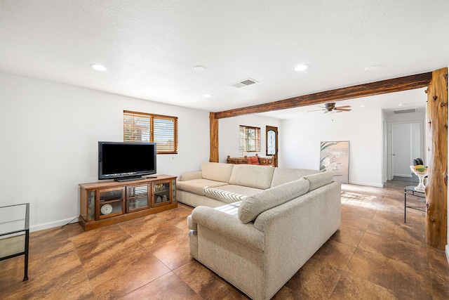 living room featuring beam ceiling, ceiling fan, and plenty of natural light