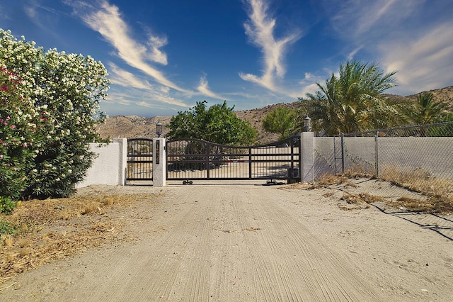 view of gate with a mountain view