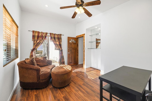 living room featuring hardwood / wood-style floors and ceiling fan