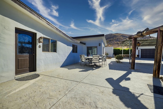 view of patio with a pergola and a mountain view