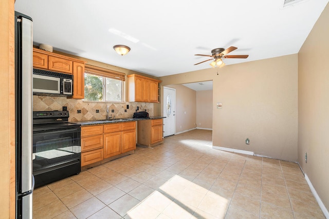 kitchen featuring sink, light tile patterned floors, stainless steel appliances, and tasteful backsplash