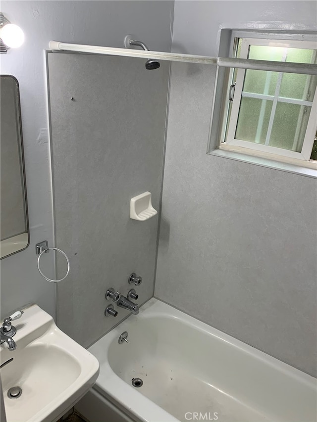 bathroom with bathtub / shower combination and sink