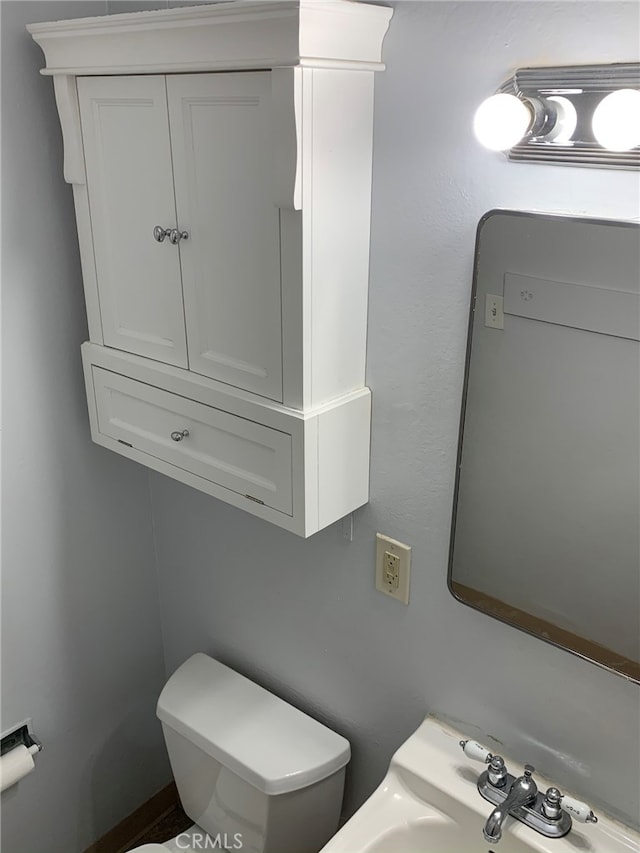 bathroom featuring sink and toilet