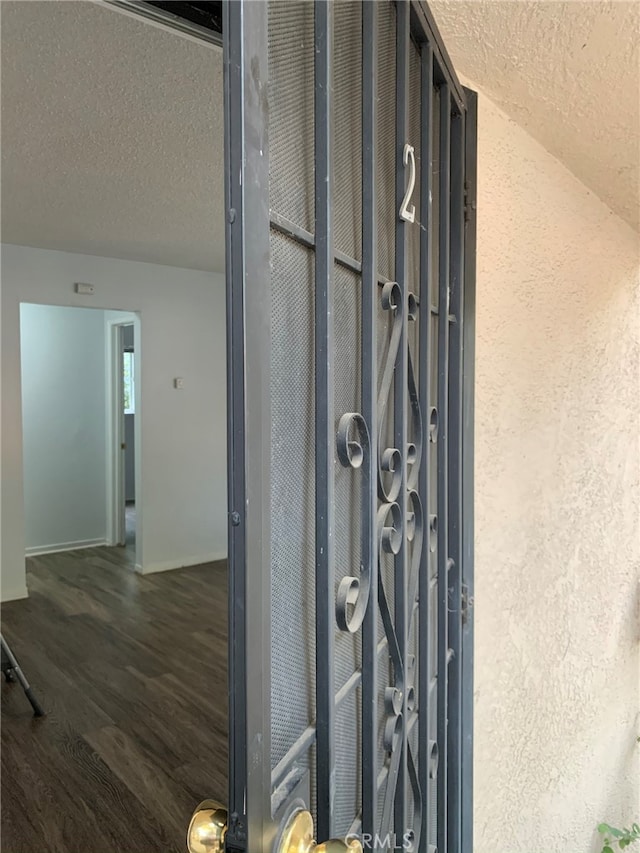 details with wood-type flooring and a textured ceiling