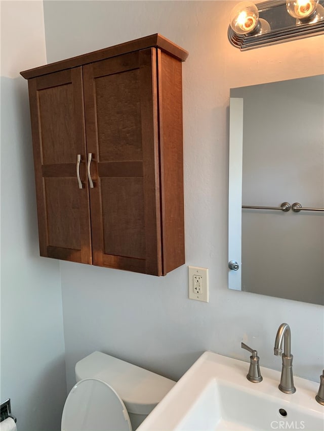 bathroom with toilet and sink