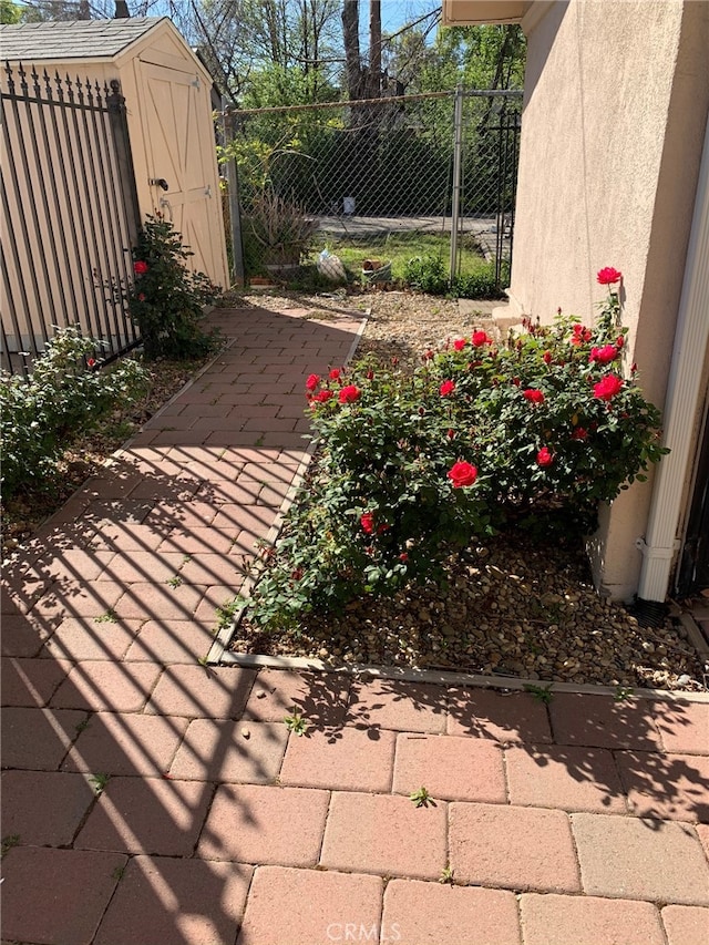 view of patio featuring a storage unit