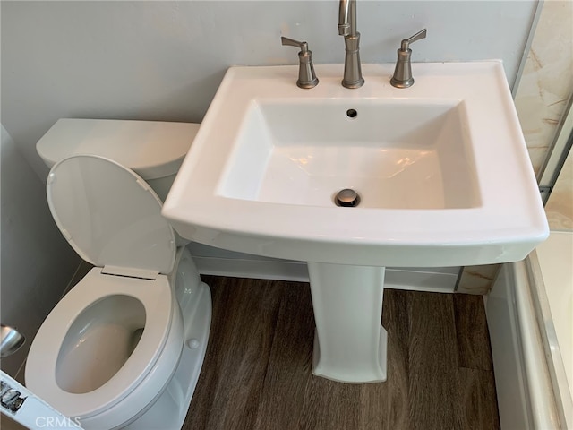 bathroom featuring toilet and wood-type flooring