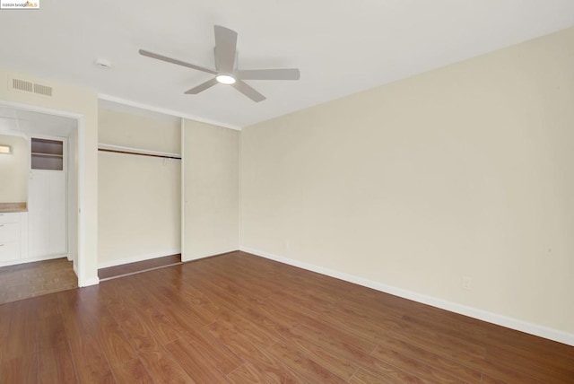 unfurnished bedroom featuring a closet, ceiling fan, and dark wood-type flooring