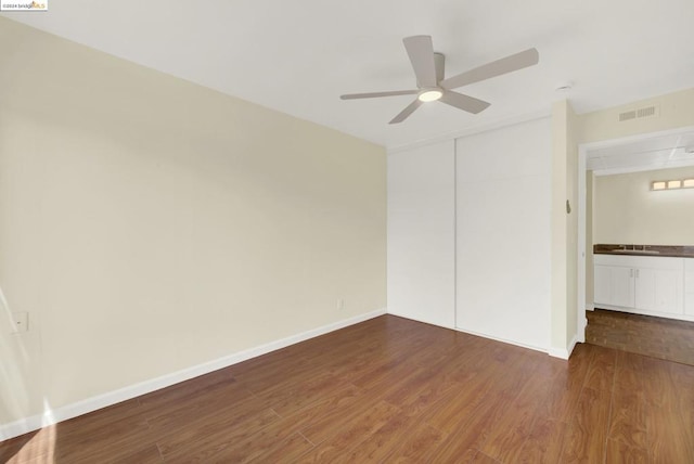 interior space featuring dark hardwood / wood-style floors, ceiling fan, and a closet