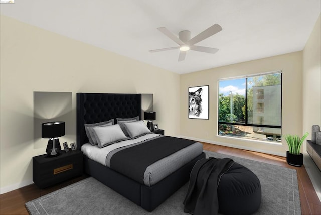 bedroom featuring ceiling fan and dark wood-type flooring