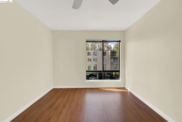 unfurnished room featuring dark hardwood / wood-style flooring and ceiling fan