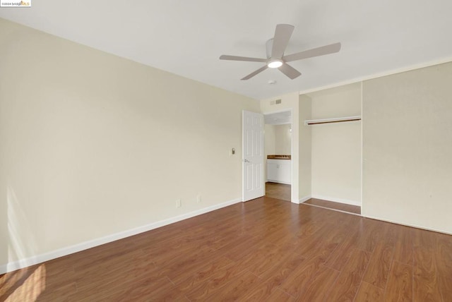 unfurnished bedroom featuring a closet, ceiling fan, and hardwood / wood-style flooring