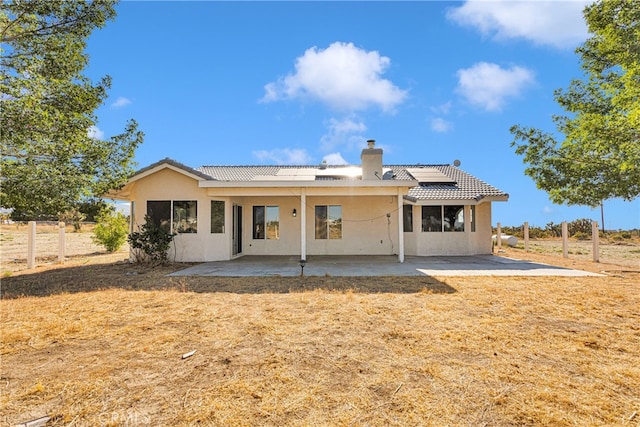 rear view of property featuring a patio