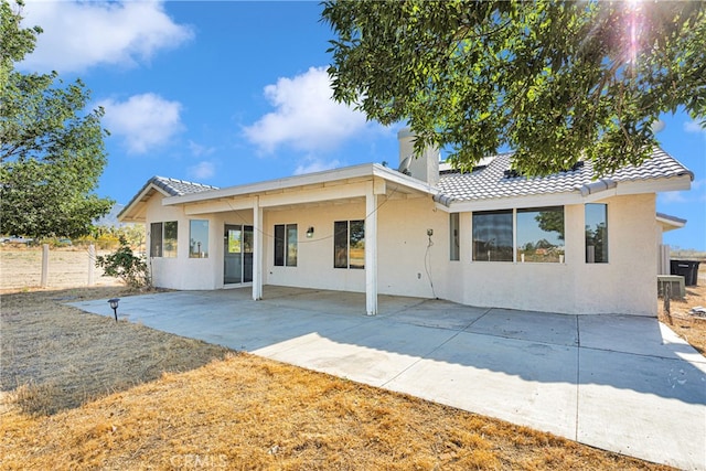 rear view of property featuring a patio area