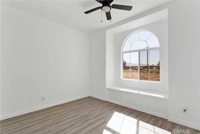 empty room featuring ceiling fan and hardwood / wood-style floors