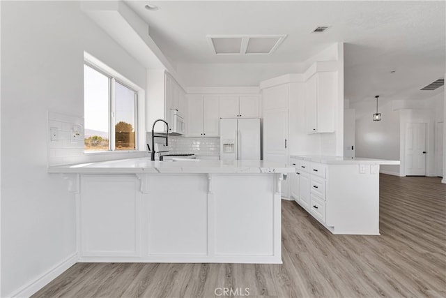 kitchen featuring white cabinetry, white appliances, and light hardwood / wood-style floors