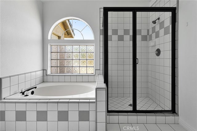 bathroom featuring separate shower and tub