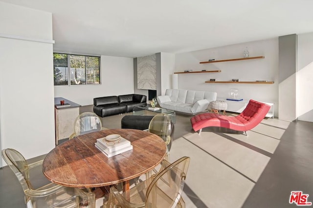 dining space featuring concrete flooring