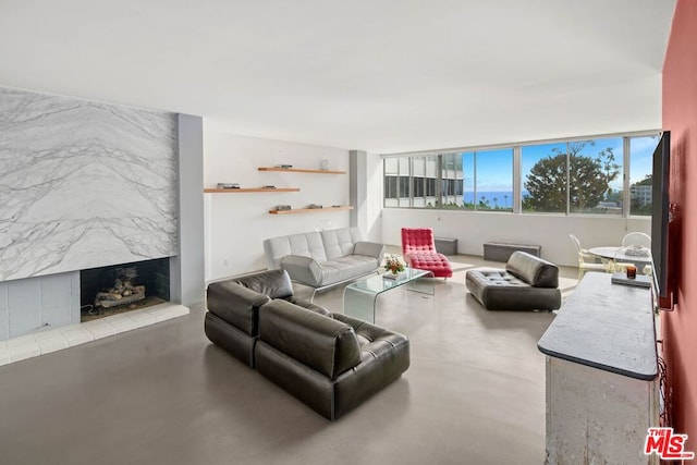 living room with a high end fireplace and concrete flooring