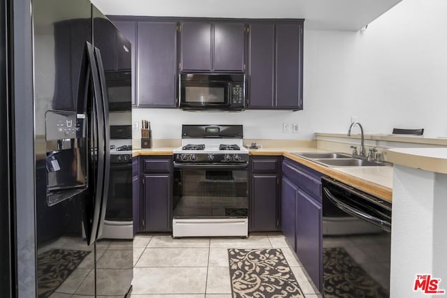 kitchen with black appliances, sink, and light tile patterned flooring