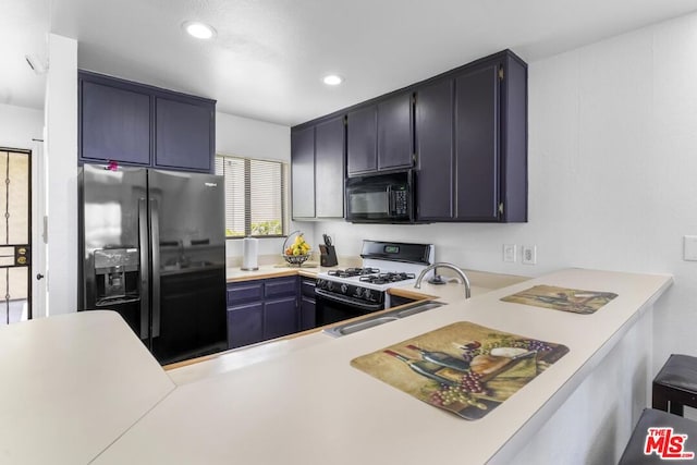 kitchen with black appliances and kitchen peninsula