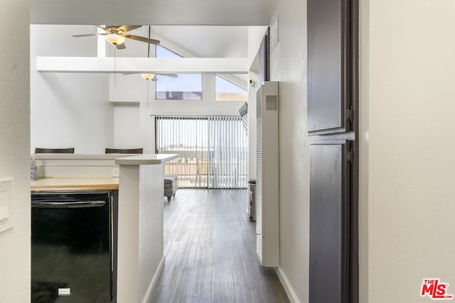 kitchen featuring ceiling fan, lofted ceiling, dishwasher, and wood-type flooring