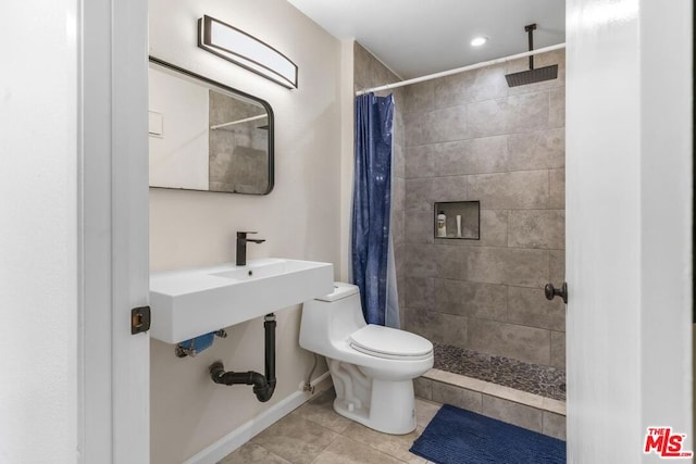 bathroom featuring toilet, tile patterned flooring, and a shower with shower curtain