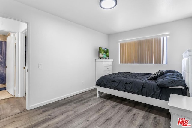 bedroom with wood-type flooring