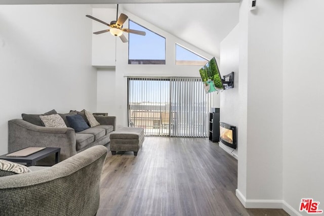 living room featuring ceiling fan, dark hardwood / wood-style flooring, and high vaulted ceiling