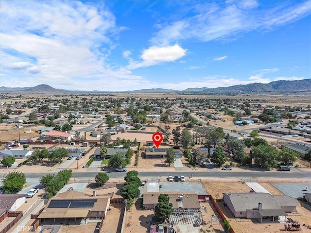 birds eye view of property with a mountain view