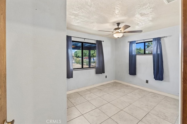 unfurnished room with a textured ceiling, light tile patterned floors, and ceiling fan