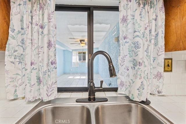 room details featuring tile countertops, sink, decorative backsplash, and ceiling fan