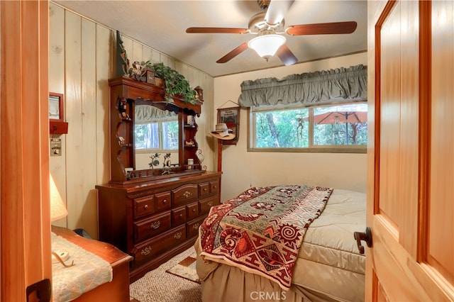 bedroom with multiple windows and ceiling fan