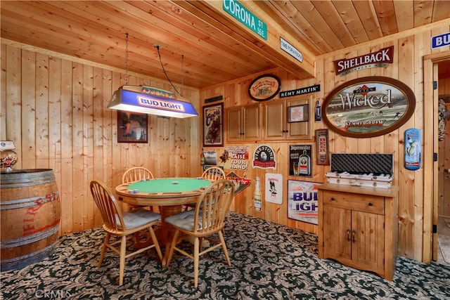 game room with wood ceiling, wood walls, and carpet floors