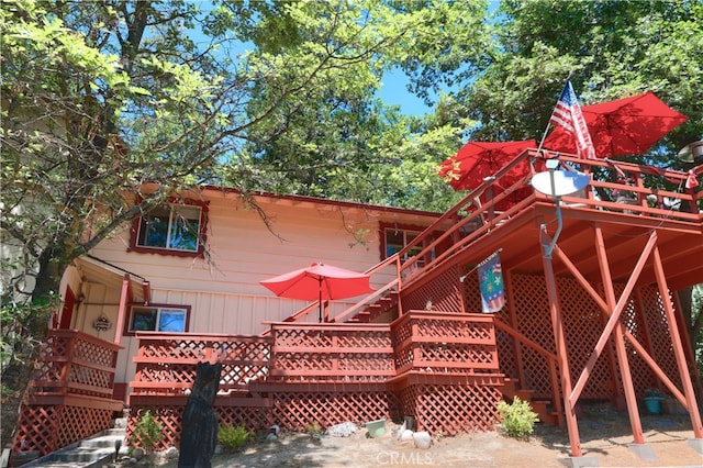 back of house featuring a wooden deck