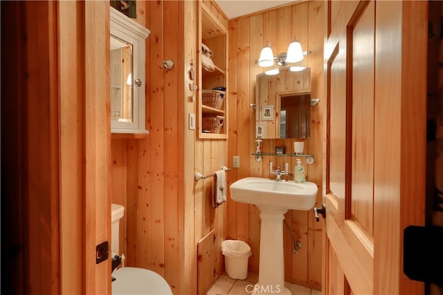 bathroom featuring toilet, wooden walls, and tile patterned flooring