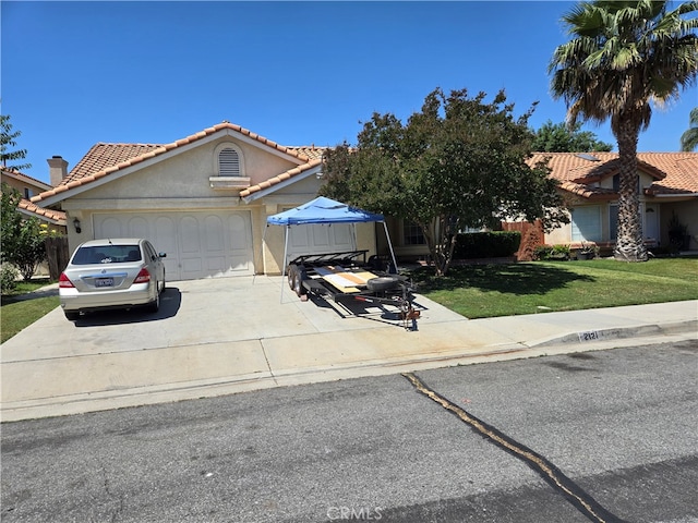 view of front of house with a garage and a front yard