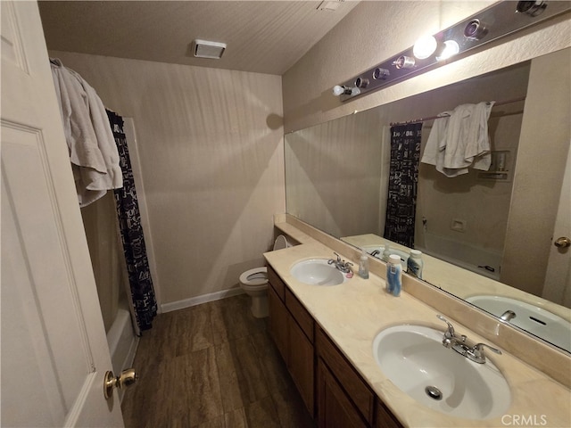 full bathroom with vanity, wood-type flooring, shower / bath combo, and toilet